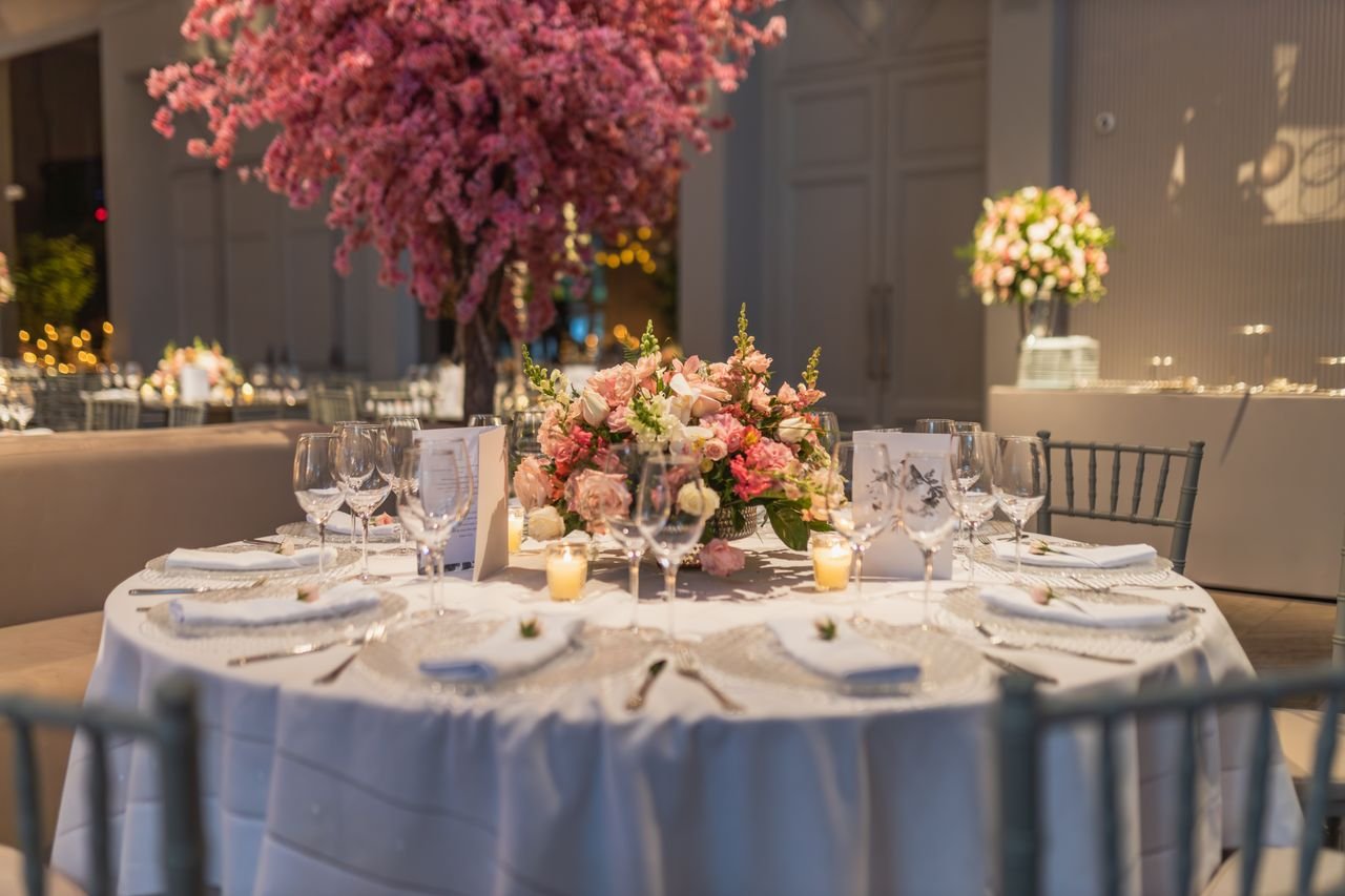 services-03 An elegant wedding reception table featuring floral decor and soft lighting, creating a warm and inviting atmosphere.